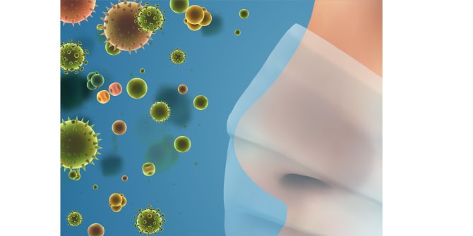 マスクをした顔の周辺にアレルギー物質のようなものが浮遊するイメージイラスト