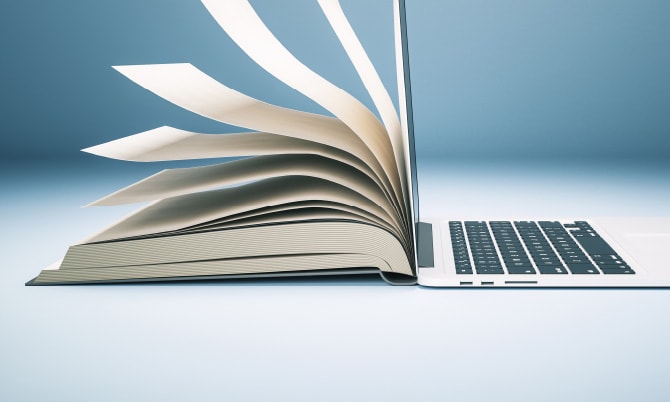 半分開いた本とノートパソコンのイメージ写真